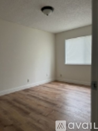 A room with wooden floors and a window.