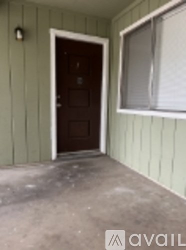 A brown door is open to a room.