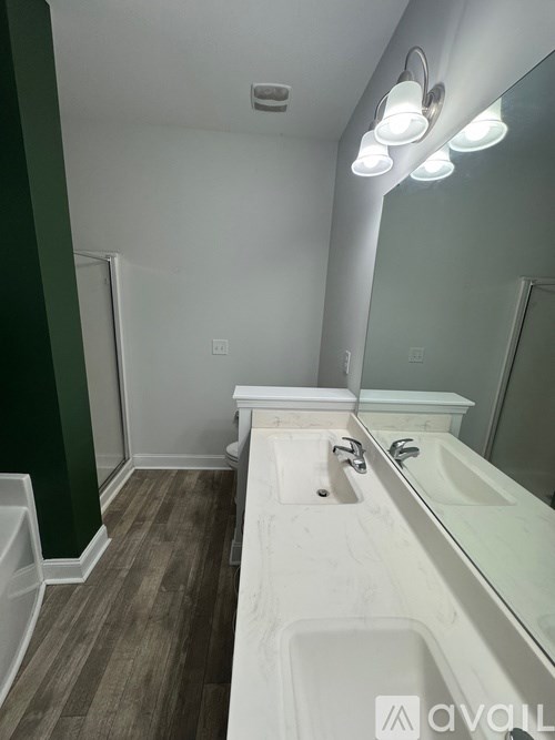 A bathroom with a white sink and a mirror.