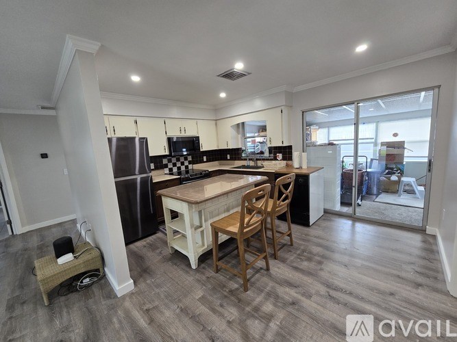 A kitchen with a table and chairs in the middle of the room.