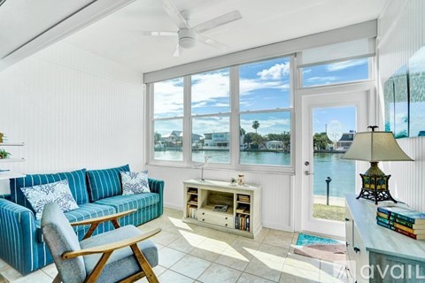 A living room with a blue couch and a fan.