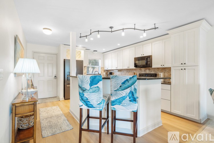 A dining room with a glass table and chairs.
