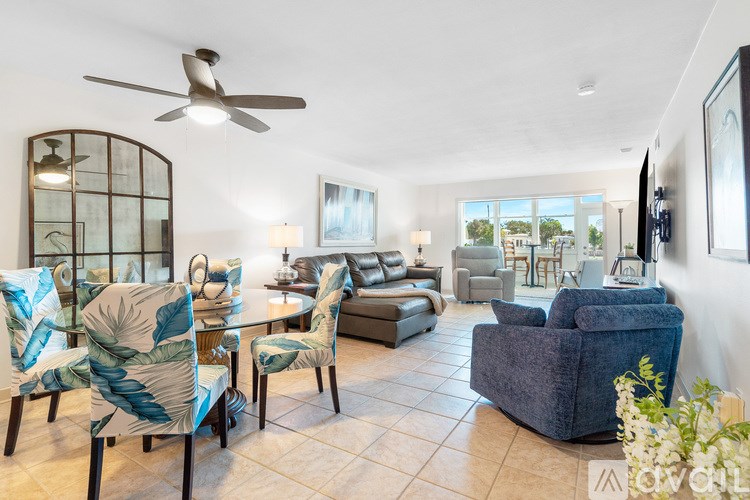 A living room with a grey sofa and a wooden side table.