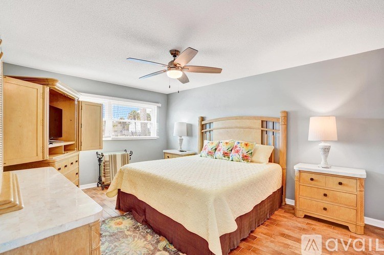 A bedroom with a bed, dresser, and window.