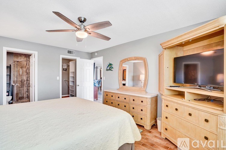 A bedroom with a bed, dresser, and mirror.