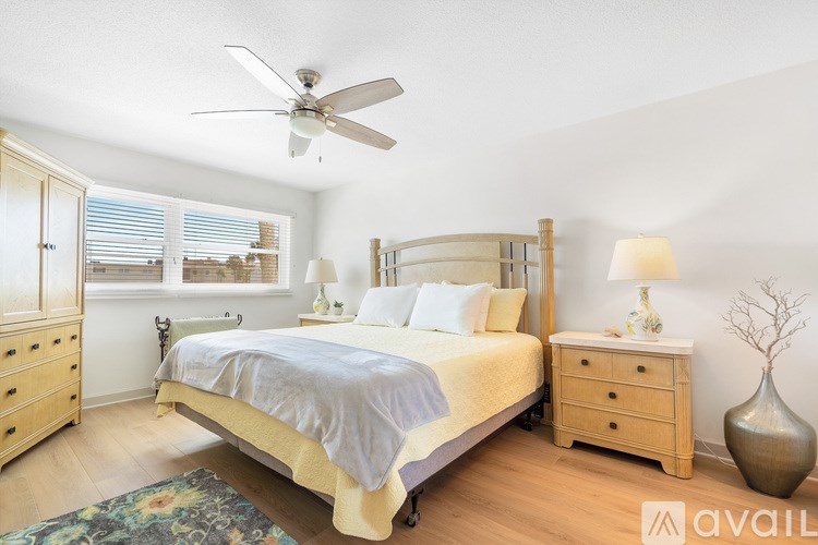 A bedroom with a bed, dresser, and mirror.