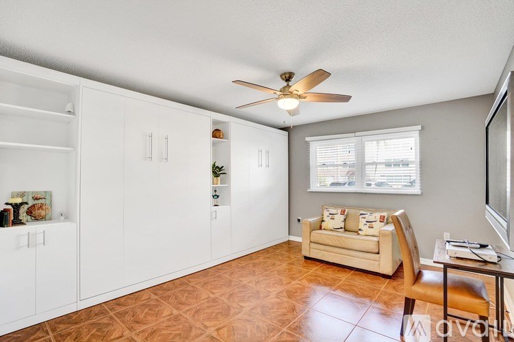 A living room with a ceiling fan and a couch.