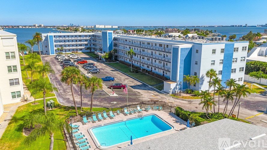 A kitchen with black appliances and white cabinets.