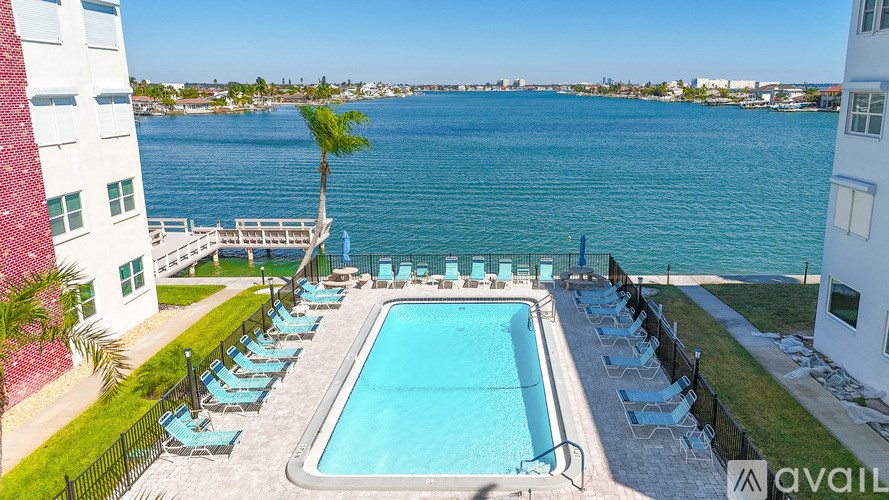 A kitchen with a black countertop and a fridge.