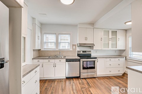 A kitchen with white cabinets and stainless steel appliances.