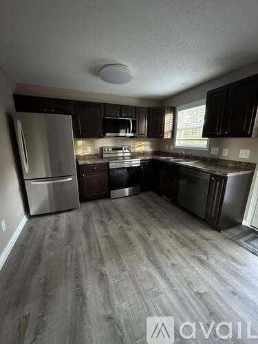 A kitchen with a refrigerator, stove, and oven.