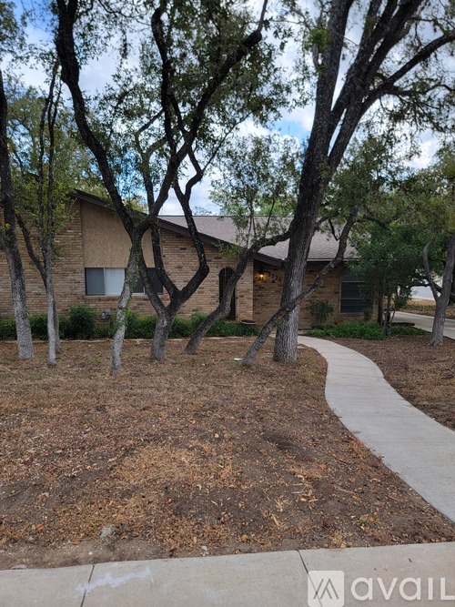 A house with a tree in front of it.