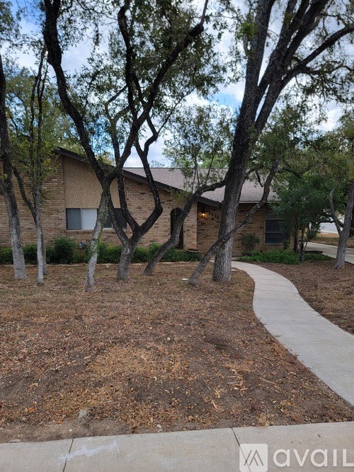 A house with a tree in front of it.