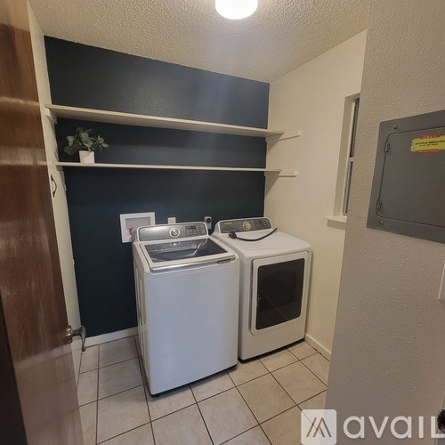 A small laundry room with a washer and dryer.