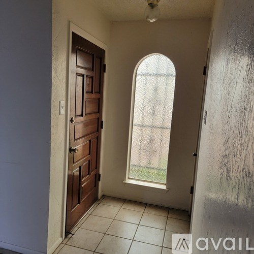 A room with a brown door and a window.