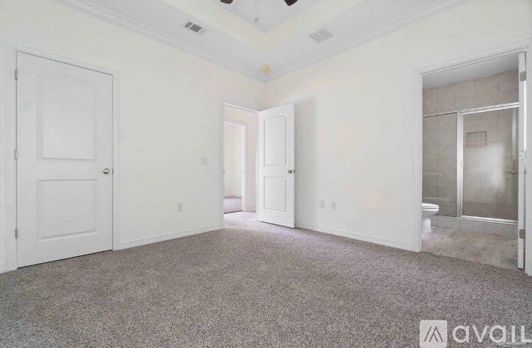 A room with white walls and a carpeted floor.