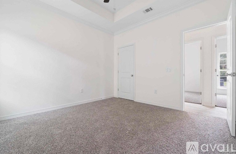 A room with carpeted floor and white walls.
