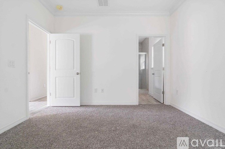 A room with a carpeted floor and white walls.