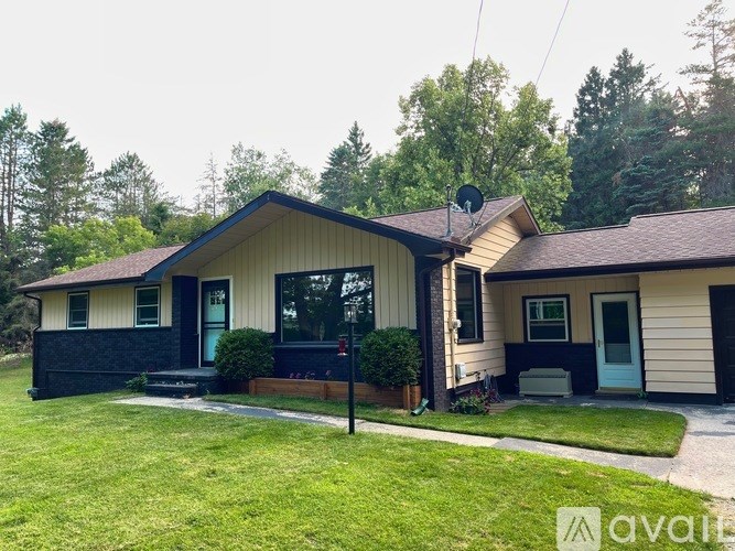 A house with a blue door and a black front porch.