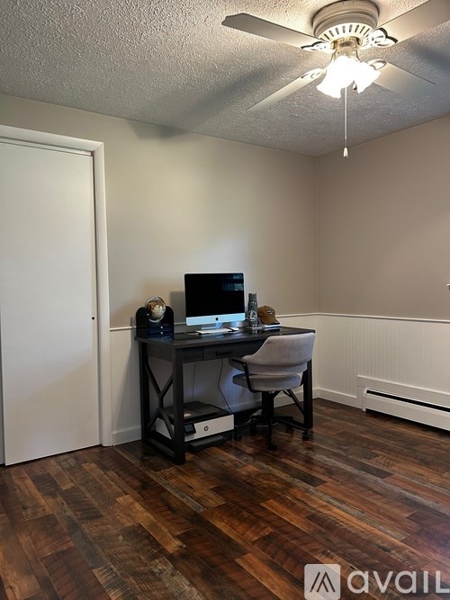 A room with a desk and a computer on it.
