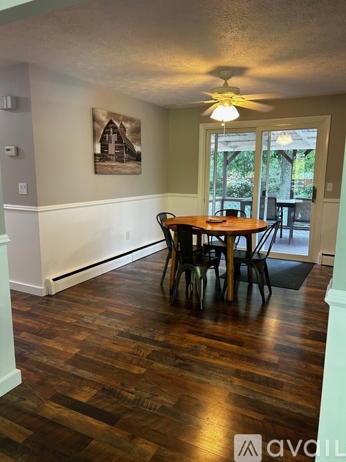 A room with a wooden floor and a ceiling fan.