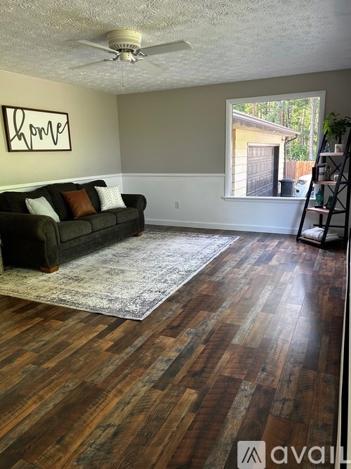A living room with a couch and a rug.