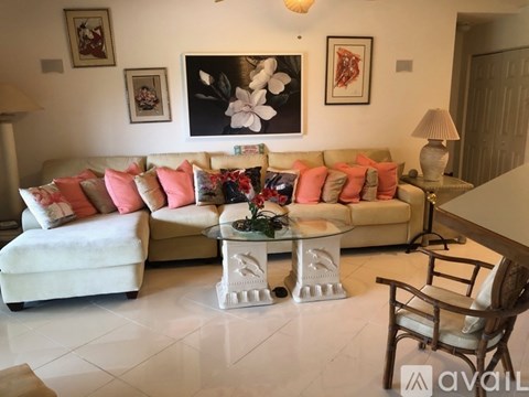 A living room with a white couch and a coffee table.