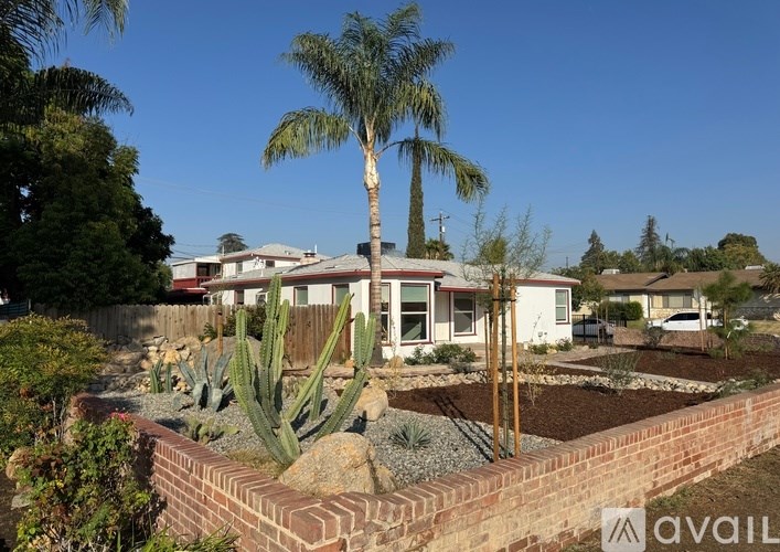 A house with a cactus in front of it.