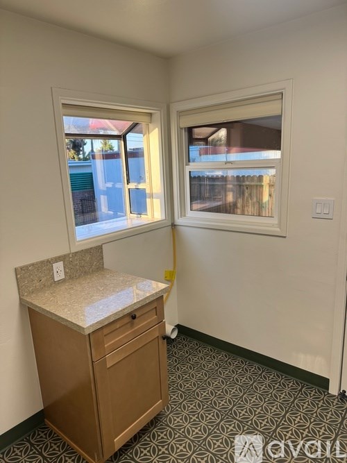 A room with a window and a sink.