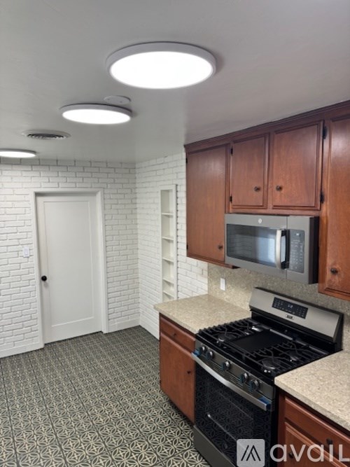 A kitchen with a stove top oven and microwave.
