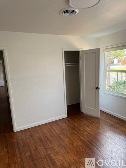 A room with wooden floors and white walls.
