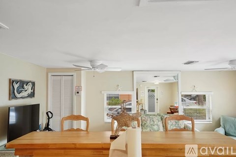 A living room with a wooden table and chairs.
