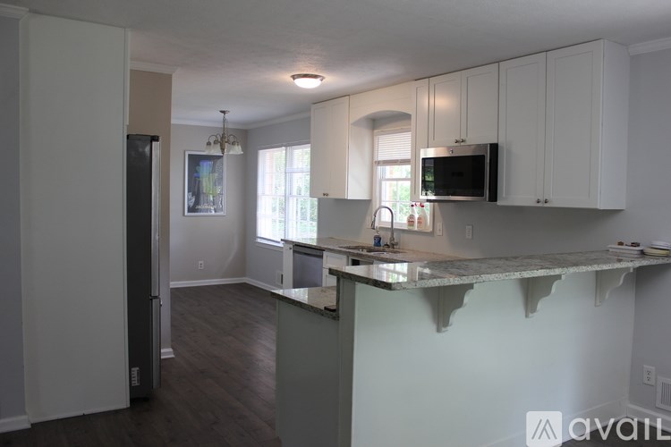 A kitchen with white cabinets and a countertop.