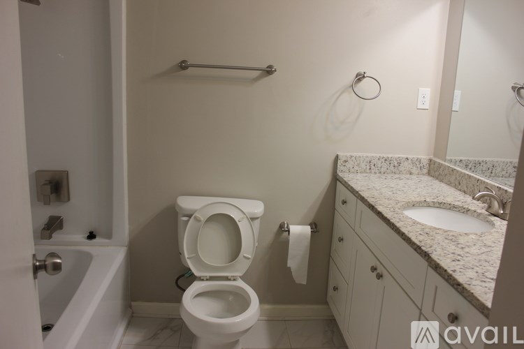 A bathroom with a toilet, sink, and bathtub.