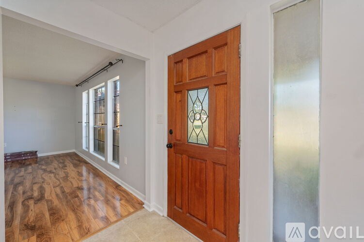 A room with a wooden door and a glass window.