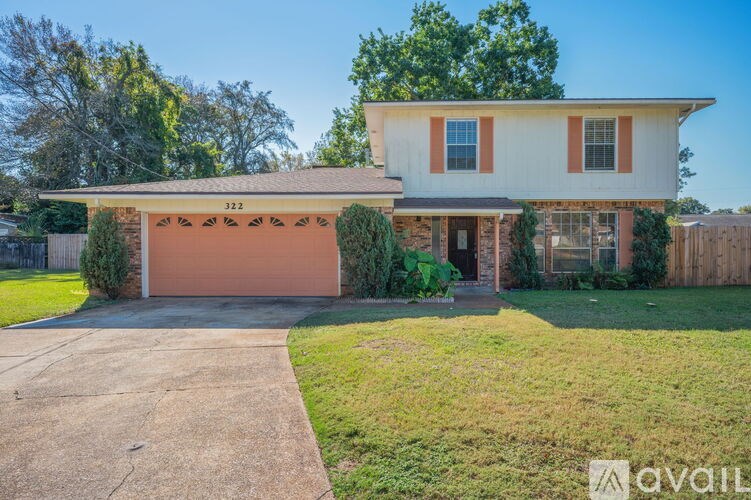 A house with a garage and a driveway in front.