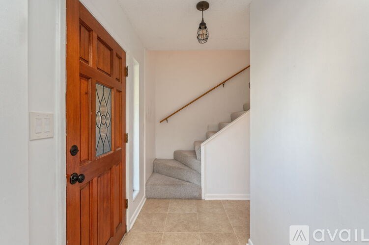 A wooden door with a glass panel is on the left side of the image.