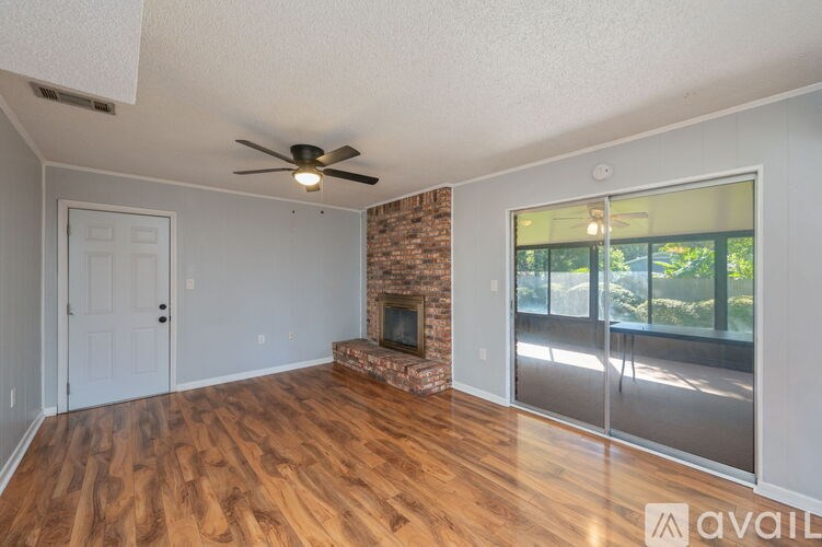 A room with a fireplace and a ceiling fan.