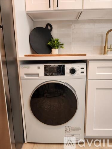 A white washing machine and dryer in a kitchen.