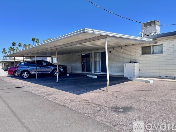 A house with a car parked in front.