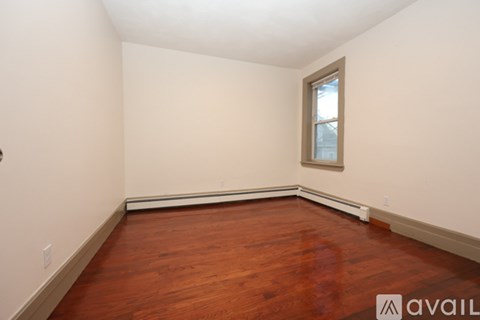 A kitchen with wooden cabinets and a marble countertop.