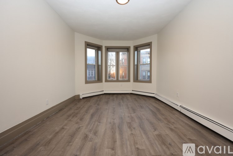 A kitchen with wooden cabinets and a window.