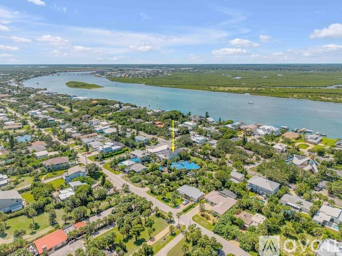 A bird's eye view of a residential area with a river running through it.