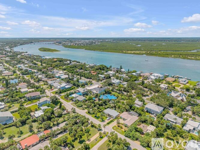 A bird's eye view of a residential area with houses and a river.