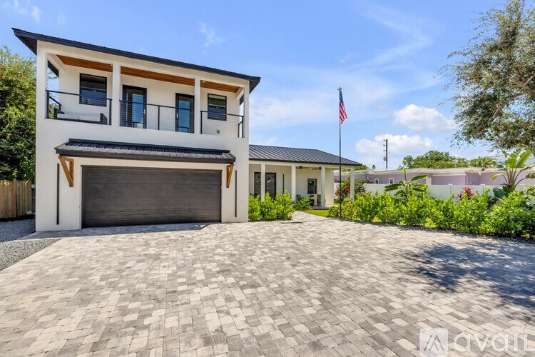 A modern house with a garage and a flag on the roof.
