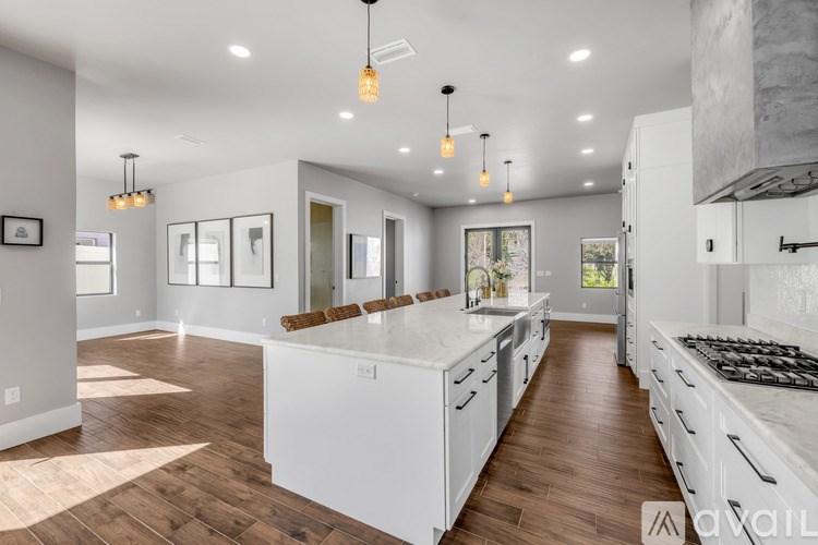 A modern kitchen with white cabinets and a central island.