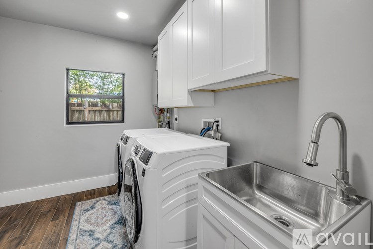 A modern laundry room with a washer and dryer.