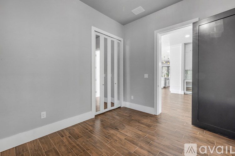 A room with a wooden floor and white walls.