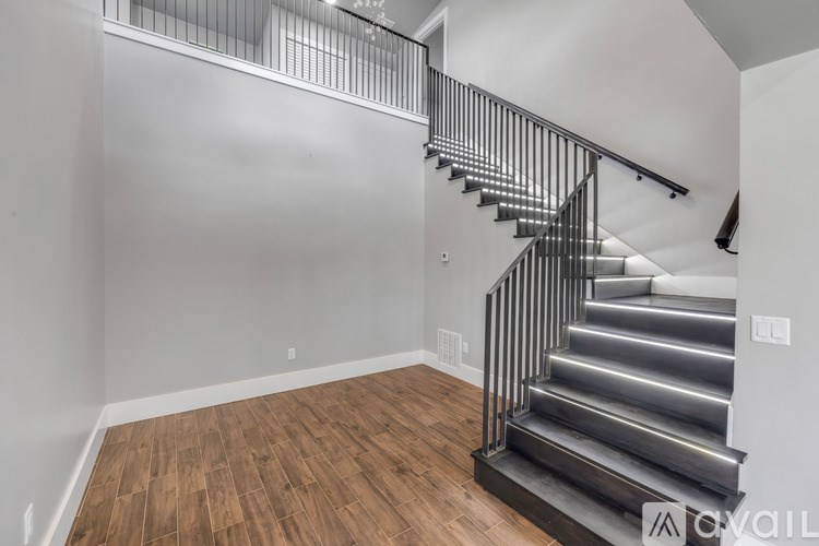 A staircase with a metal railing and wooden steps.