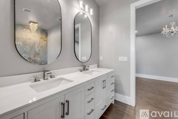 A bathroom with two sinks and two mirrors.
